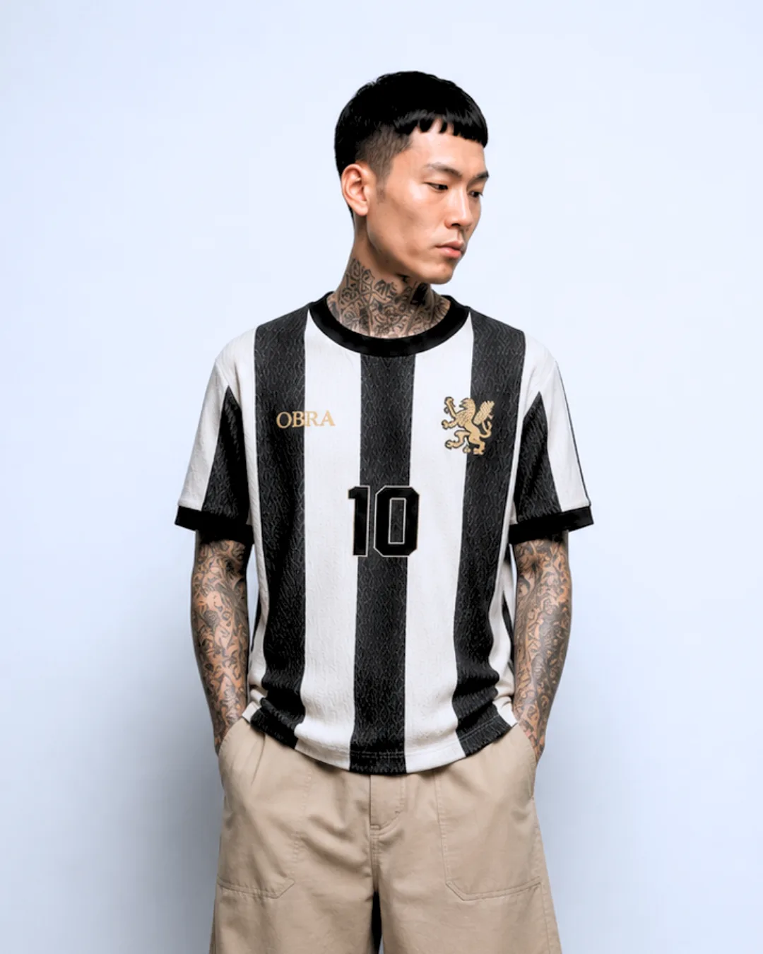 OBRA black-and-white striped football jersey with number 10, worn by a model